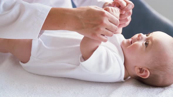 Female Pediatrician Doctor with Baby at Clinic