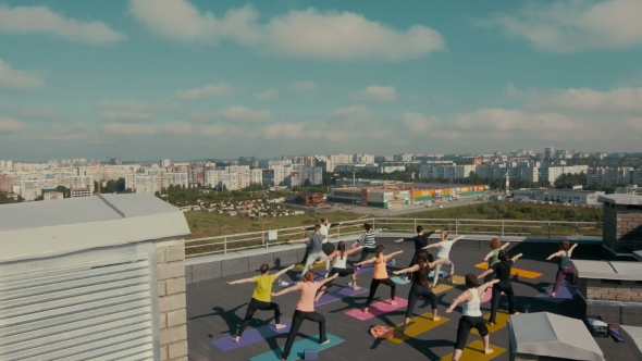 People Engaged in Yoga on the Roof.