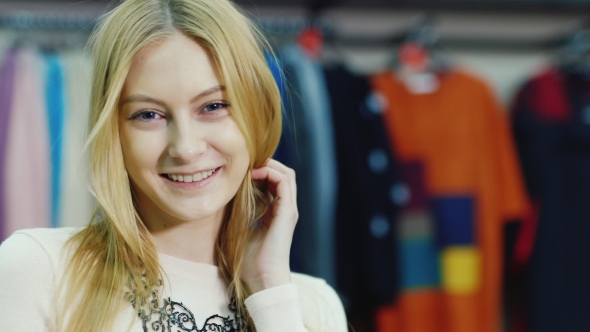 Portrait of Young Woman Model Looks at a Clothing Store