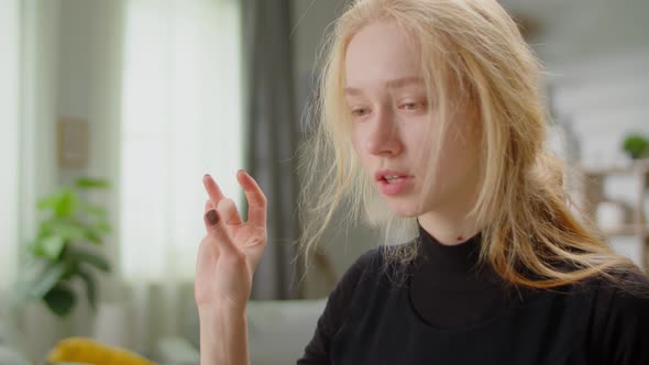 Young Beautiful Woman Learning Sign Language at Home in Living Room Using Online Lesson