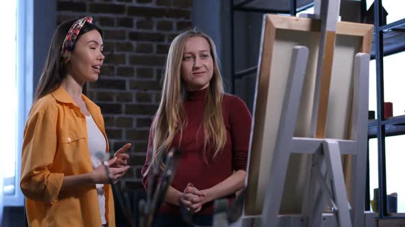 Female Painter Discussing Artwork with Friend