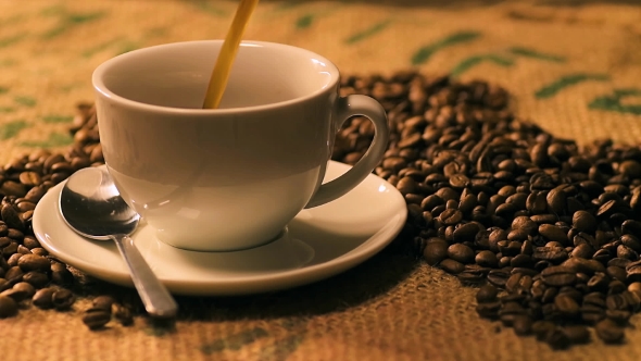 Coffee Poring Into A Black Cup