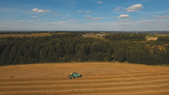 Aerial View Combine Harvesting a Field of Wheat.