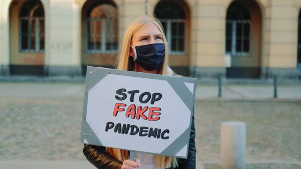 Young Woman in Protective Mask Protesting Against Fake Pandemic