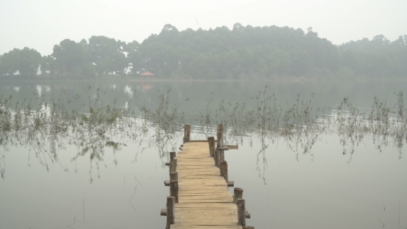 Wooden Bridge in the Misty Lake