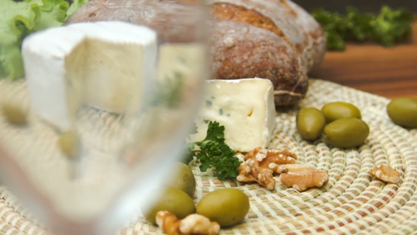 White Wine Is Poured Into a Glass and Camembert Cheese