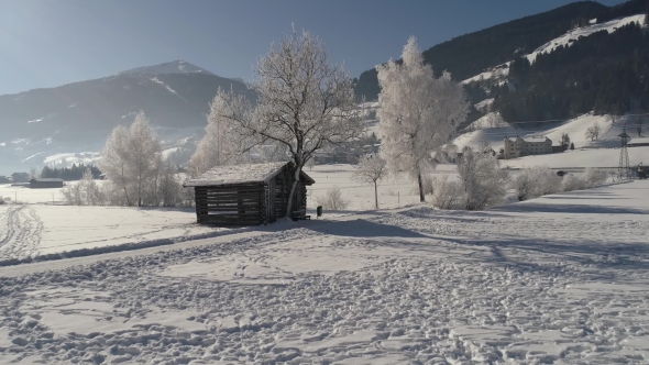 Barn in the Snow-covered Field