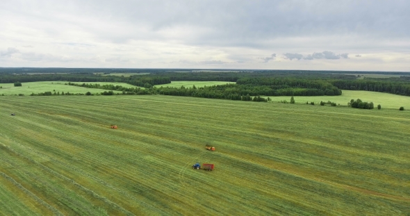 A Drone Footage of a Harvesting Machine on a Large Field