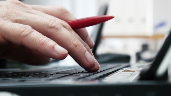 Businessmans Hands Typing on Laptop Keyboard