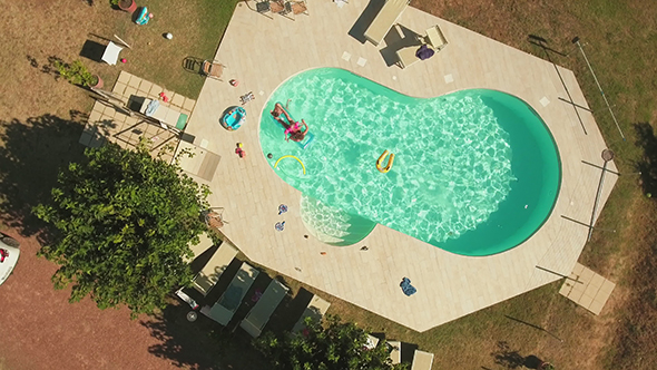 Rotating Drone Footage of Family Enjoying in Swimming Pool