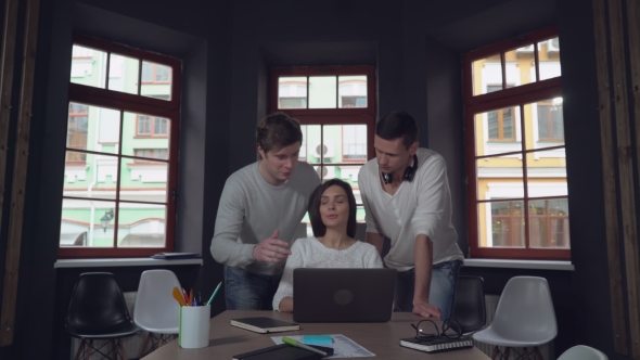 Three Happy People Looking on Pc Screen and Smiling.