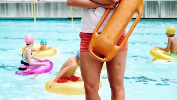 Portrait of swim coach standing with arms crossed