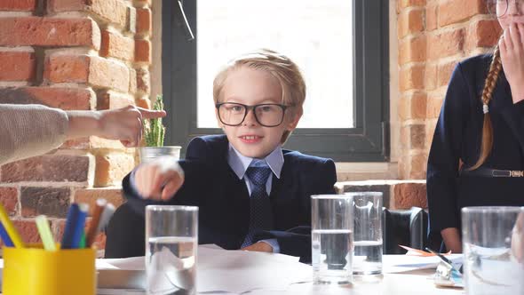 Young Business Children Pointing To Each Other, Having an Argument