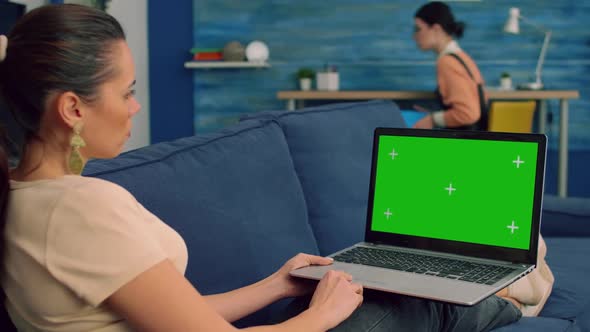 Business Woman Working on Laptop Computer with Mock Up Green Screen