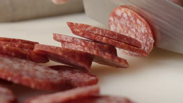 Cured sausage of air-dried meat cutting 4K 2160p 30fps UltraHD footage - Salami cut on smaller piece