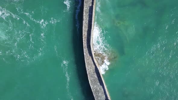 Top-down Shot Of Portreath Pier With The Famous Monkey Hut At The End In Cornwall, UK - aerial