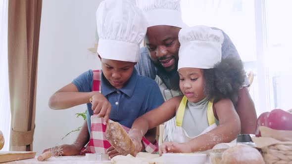 Joyful African American family cooking dinner together. Happy family