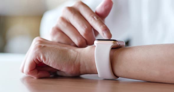 Woman use of smart watch in the cafe