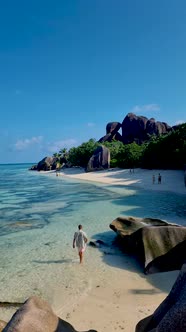 Anse Source d'Argent La Digue Seychelles Young Couple Men and Woman on a Tropical Beach During a