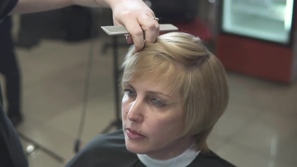 Young Woman Getting Her Hair Dressed in Hair Salon