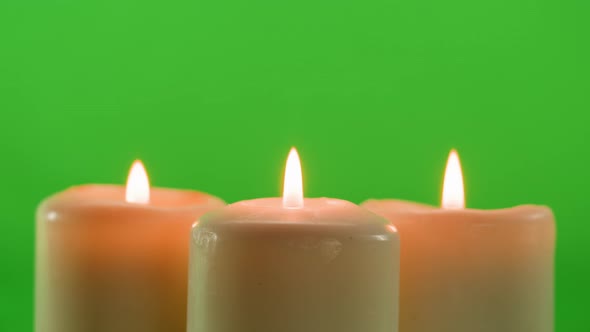 Burning Wax Candles on Green Chroma Key Background