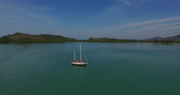 Aerial: Flying Around Lonely Sailboat in the Sea