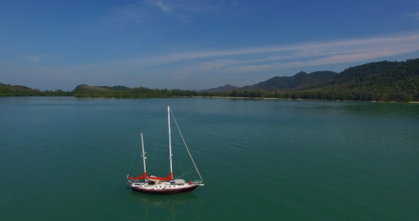 Aerial: Lonely Red Sailboat in the Sea.