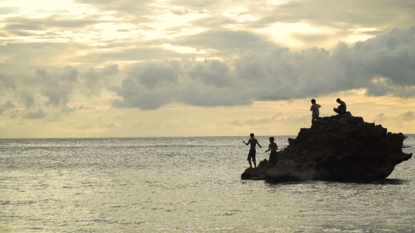 Children on a Rock in the Sea Fishing.