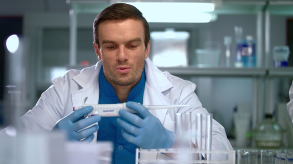 Researcher in Lab. Scientist Man with Pipette in Lab. Scientist Student alt