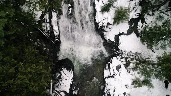 Drone Flying Up Snowy Forest River Waterfall