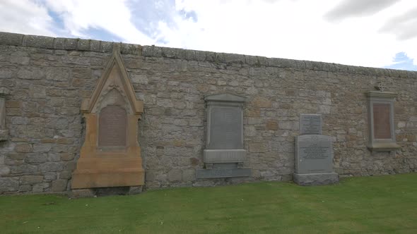 Tombstones in a stone wall