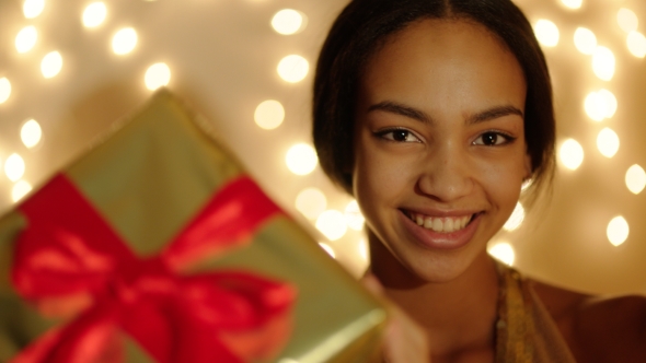 Beautiful Young Woman Keeping Big Gift Box in Her Hands and Smiling
