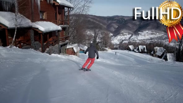 Rear View of Professional Skier Carving Down the