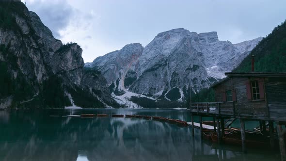 Wooden house and boats on lake in mountains
