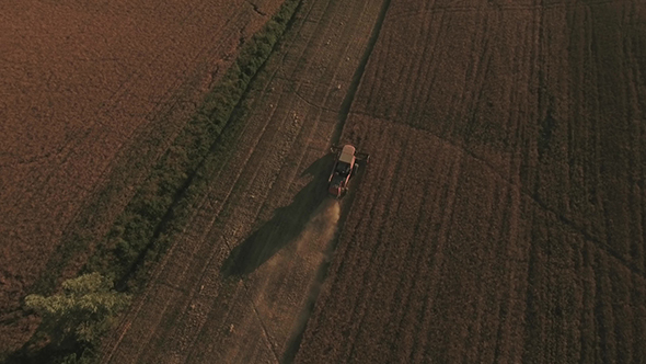 Aerial Footage of Combine Harvester in Crop Fields