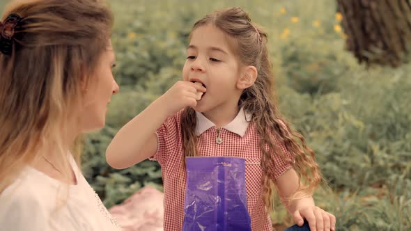 Daughter With Cheerful Mom Eat Candy. Preschool Girl Having Fun And Eats Jelly Candies.