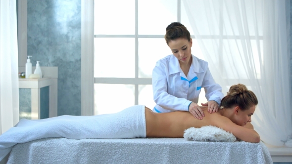 Woman Having Massage of Body in the Spa Salon.