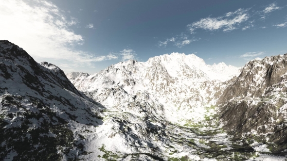 Mountains in Snow and Clouds at Blue Sky alt