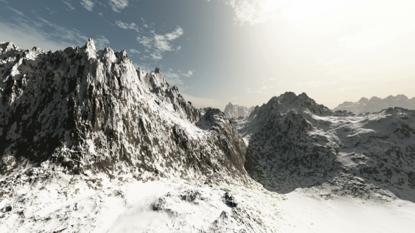 Mountains in Snow and Clouds at Blue Sky