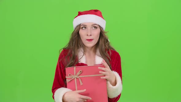 Girl in a Snow Maiden Costume Holds a Gift . Green Screen. Close Up