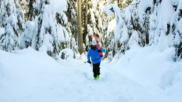 Person walking with snowboard and ski pole 4k