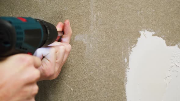 Man Builder Using Electric Screwdriver Closeup