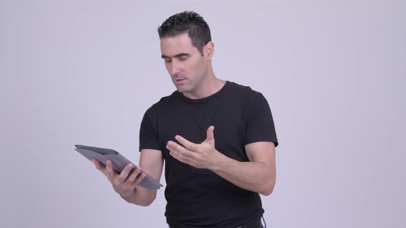 Stressed Man Using Digital Tablet and Getting Bad News