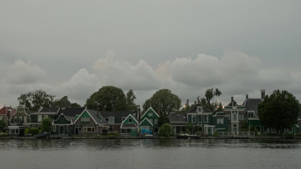 Clouds Over Houses on River Bank, Netherlands