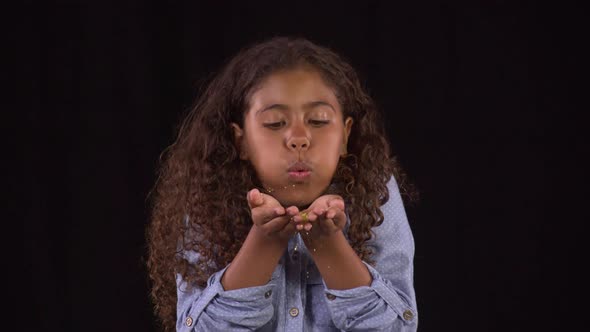 Cute Little Girl Blowing Glitter