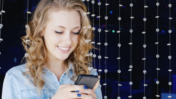 Young Woman Typing a Message on a Smartphone