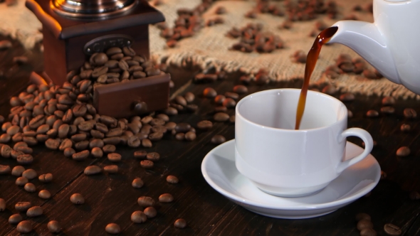 Black Hot Coffee Poured Into White Cup From Coffee Pot