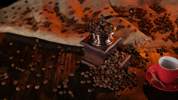 Table with a Coffee Grinder Full of with Coffee Beans