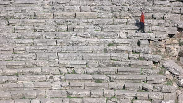 Woman Tourist Walking in Ancient Roman or Greek Ruines of Antique Amphitheater