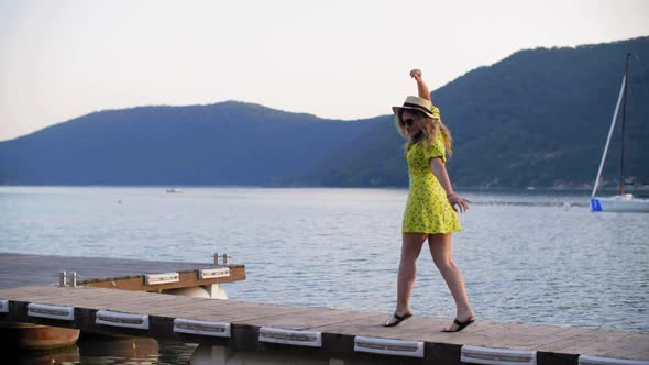 Beautiful Happy Young Woman Posing on Pier Near Sea Bay